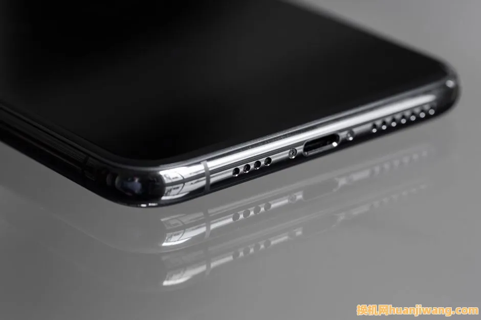 Detailed close-up of a smartphone's edge with a reflective surface, emphasizing sleek design.