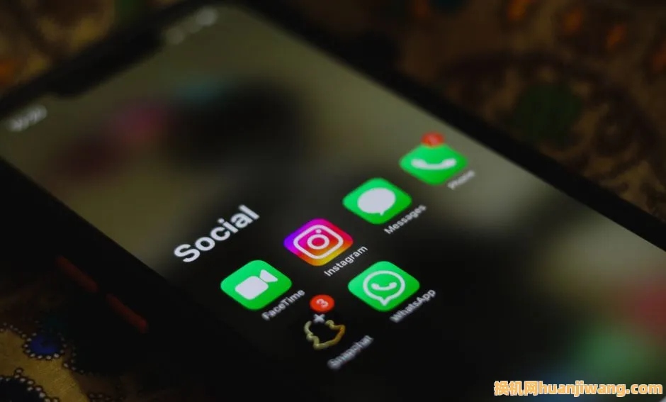 A close-up shot of smartphone displaying social media apps icons on screen.