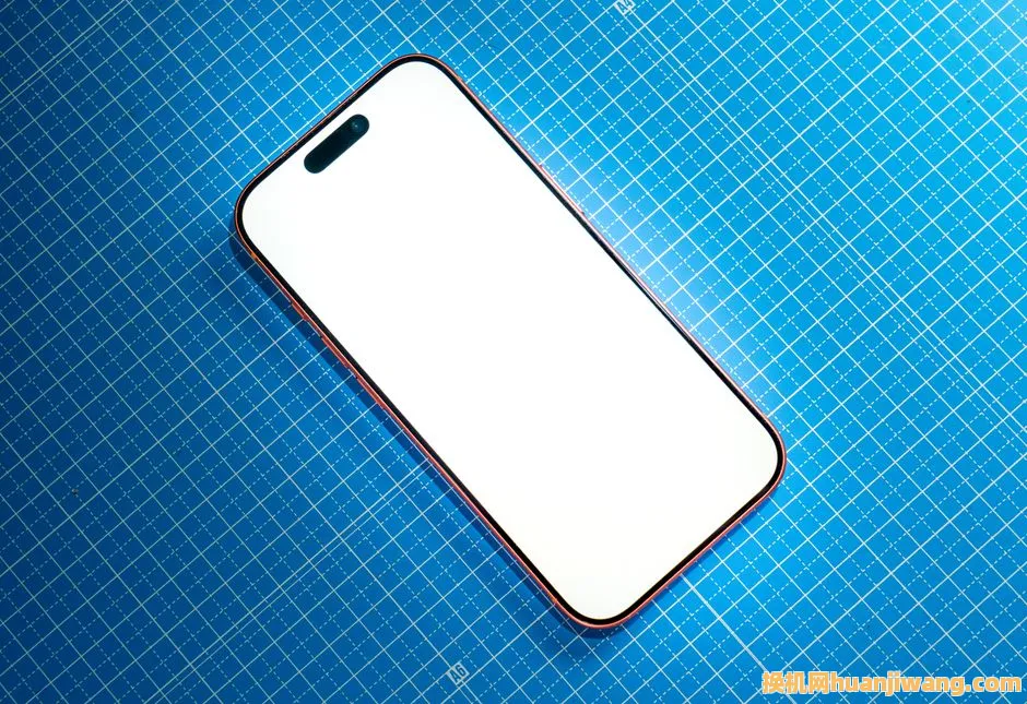Top view of a modern smartphone with a blank white screen on a blue grid surface.