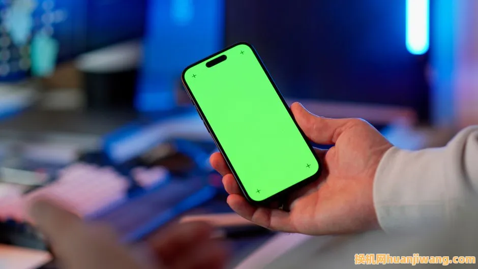 Hand holding a smartphone with a green screen in a modern indoor setting, ready for app design or mockup.