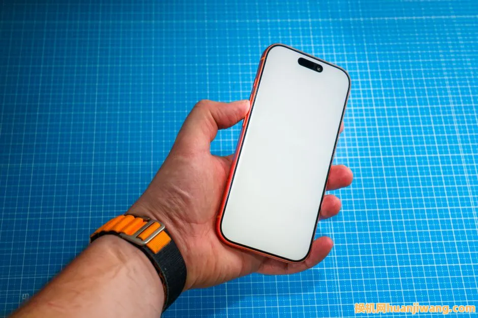 Hand holding a modern smartphone with a blank screen over a blue grid background.