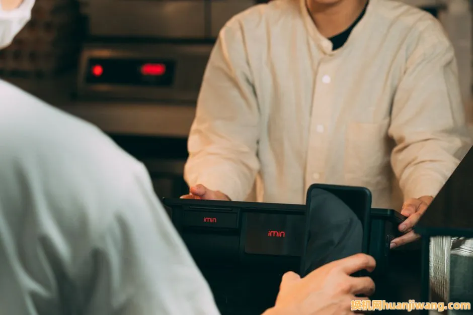 Digital payment using smartphone at a modern POS terminal indoors.