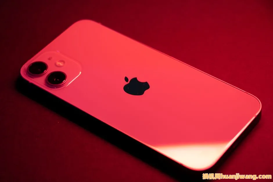 Close-up of a red smartphone with dual lenses on a red backdrop, highlighting sleek design and technology.